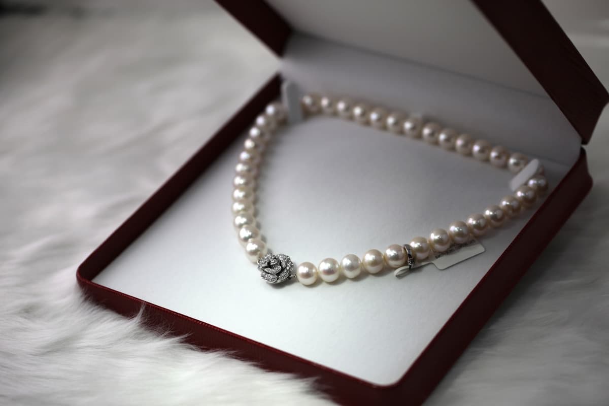 Layered gold permanent jewellery — close-up of delicate chains and bracelets